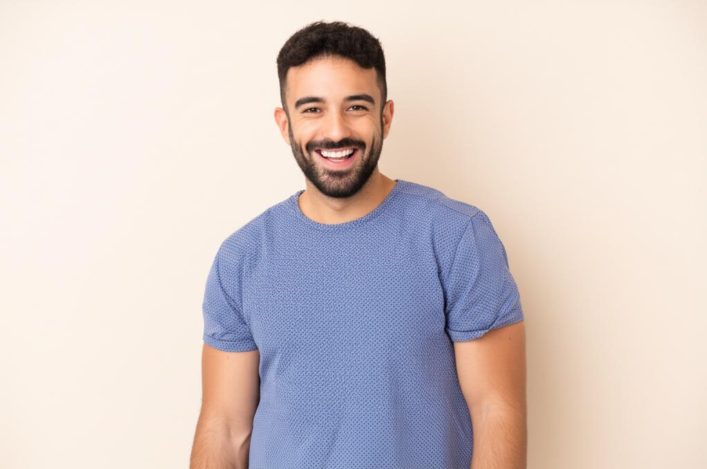 A man smiling confidently, representing renewed energy and vitality.